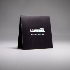 Black cardboard card with white lettering “Schiebel Multi Role - Multi Tool”