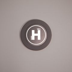 Round charger with a helicopter landing pad and a small drone