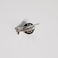 Pin badge in the shape of a drone with the “SCHIEBEL” logo across the body