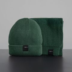 Green hat and scarf side by side, both with black label and white drone on them